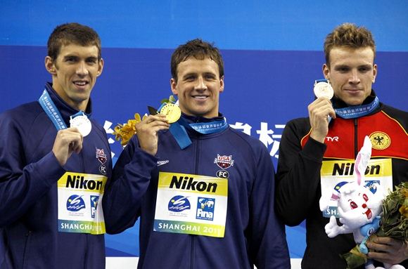 Reuters/Scanpix nuotr./200 metrų peteliake prizininkai Ryanas Lochte (centre), Michaelas Phelpsas (kairėje), Paulas Biedermannas (deainėje)