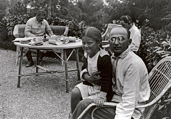 Photo from Wikipedia.org / Svetlana, the daughter of Joseph Stalin, sits on the roads of Lavrentius Beria as a child.  In the background at the table - J. Stalin