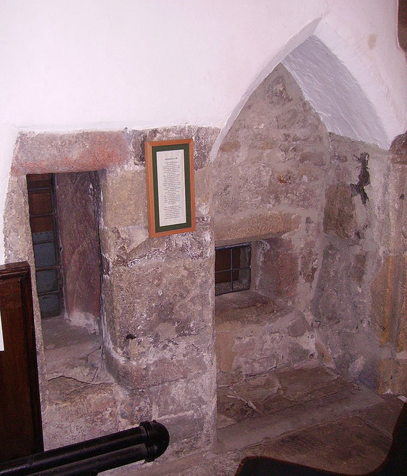 Photo from Wikimedia Commons / Anachorette cell in the UK from inside the church