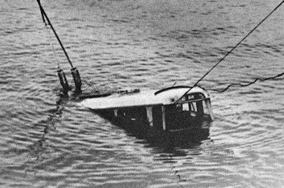 A trolleybus is pulled out of the lake